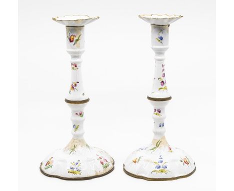 A pair of mid 18th Century Battersea enamel candlesticks, circa 1750, bobeches, knopped stems, circular domed bases, painted 