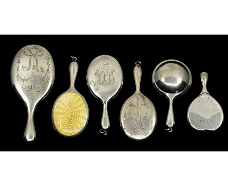 A collection of six miniature or toy silver hand mirrors, three with bright cut engraved backs, one heart shaped, one yellow 