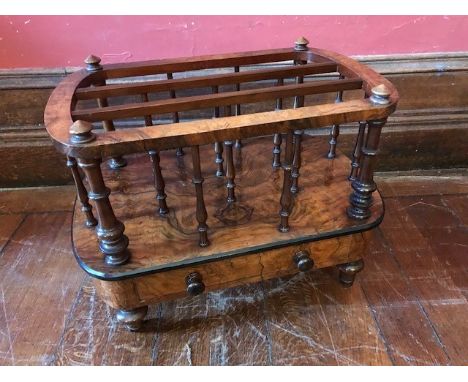 A mid Victorian figured walnut canterbury, circa 1860, triple section with baluster turned supports, single frieze drawer wit