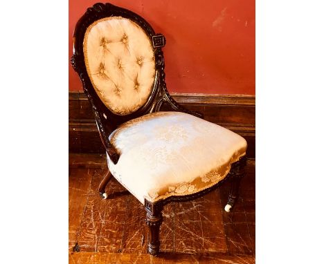 A mid Victorian walnut spoon back parlour chair, circa 1850, foliage carved frame, champagne damask button back upholstery, s