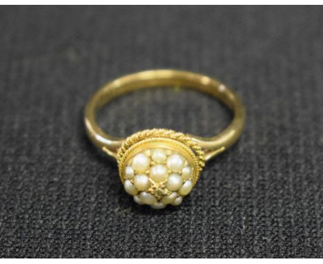 A diamond and seed pearl cluster ring, central old rose cut diamond within a dome of fifteen mabe and seed pearls, above floa