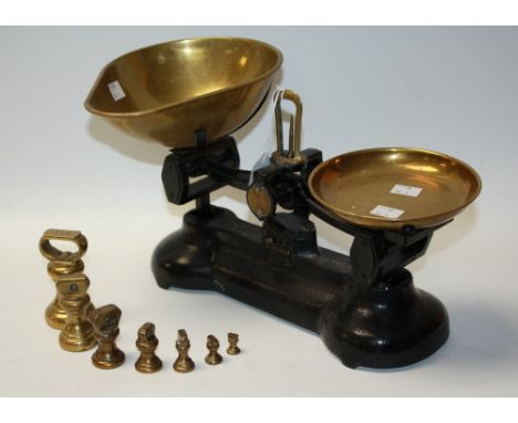 A set of Libra Scale Co cast iron balance scales, brass pans; a set of seven graduated bell weights