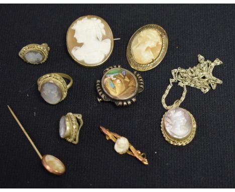 An Edwardian 9ct gold mounted cameo brooch, stamped 9ct; others gold plated, similar stickpin, a four piece carved mother of 