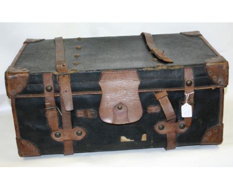 A brown leather bound travelling trunk
