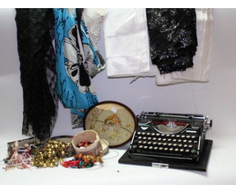 A Continental typewriter, made in Saxony, linen, bead trimmings, etc