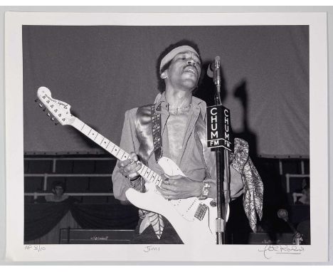 A limited edition print of an image by photographer John Rowlands depicting Jimi Hendrix onstage in Toronto, 1969. Signed by 