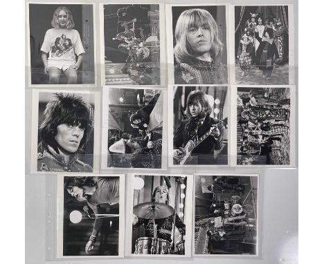 Eleven vintage prints (each c 8x10") each with scenes depicting John Lennon, members of The Rolling Stones, The Who and anoth