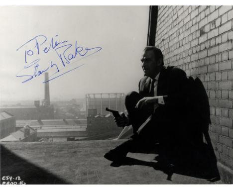 BAKER STANLEY: (1928-1976) Welsh Actor. Vintage signed and inscribed 9.5 x 7 photograph of Baker seated on a rooftop, holding