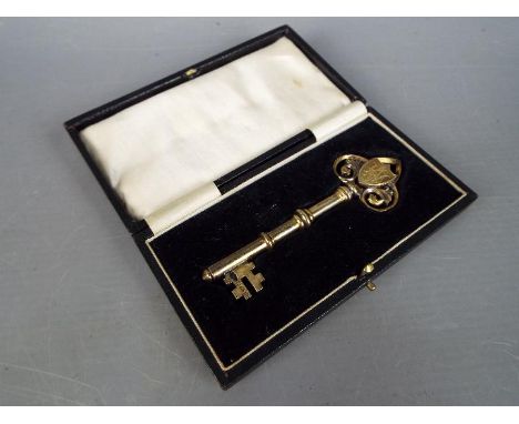 A George V silver gilt and enamel presentation key contained in fitted case, Birmingham assay 1926.