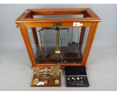 A Griffin &amp; Tatlock 250 g balance in glazed mahogany case, a set of postal scales and weights. [2]