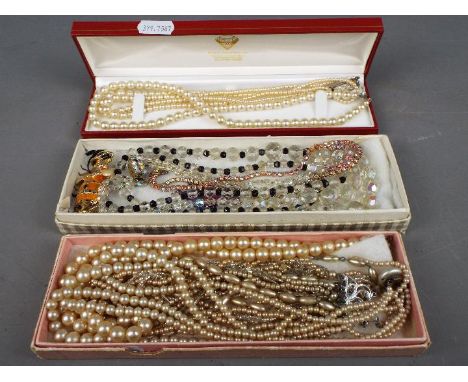 A mixed lot of costume jewellery to include five sets of various pearl necklaces, brooch and similar. (3)