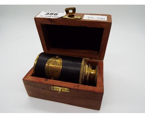 A boxed brass and leather telescope