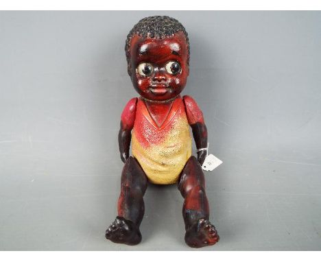 Celluloid Doll - a string jointed black Americana boy doll with black textured hair and kewpie eyes jointed arms and legs mar