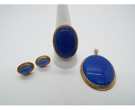 A 9ct yellow gold ring set with large blue cabochon (approximately 2.5 cm length), size R, with a matching pendant and earrin