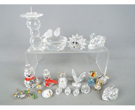 A collection of Swarovski and similar to include swans, candlestick, animals and other.