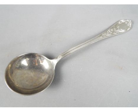 An Italian ladle with scrolling floral decoration to the handle, stamped .800, approximately 162 grams all in.