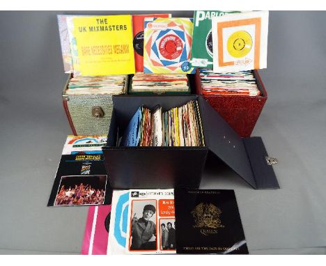 A collection of 45 RPM vinyl records contained in four carry cases to include Queen, Deep Purple, The Rolling Stones, The Mon