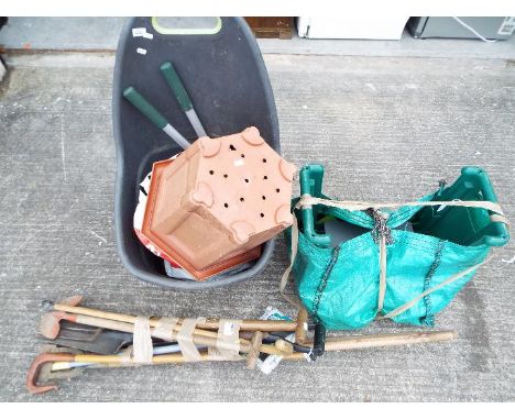 A quantity of gardening tools and accessories, planters and similar. [3]