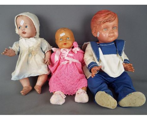 Vintage Dolls - two vintage dressed moulded dolls, one with voice box and a plastic moulded doll, marked SD to shoulders