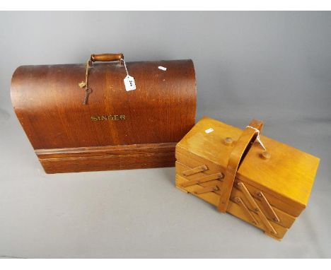 A vintage Singer sewing machine in wooden case and a sewing box with contents. [2]