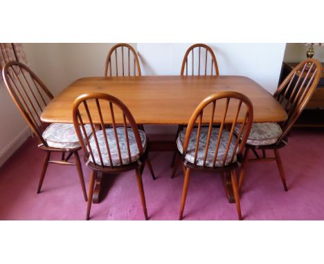 Ercol mid 20th century oak refectory style dining table, plus 6 stick back dining chairs. Table Approx. 72cms H x 153cms W x 