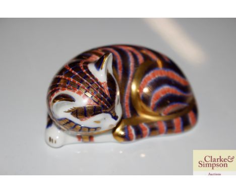 A Crown Derby paperweight in the form of a cat with silvered button mark