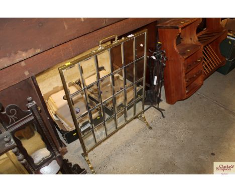 A brass and bevelled glass fire screen 