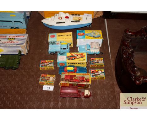 A small collection of Corgi and Merit die-cast vehicles and station accessories with original boxes