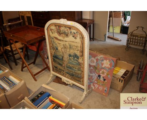 A 19th Century cream and gilt decorated fire screen with embroidered cherub panel AF; and an unframed embroidered picture