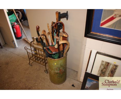 A stick stand and contents of various walking sticks, umbrellas etc. 