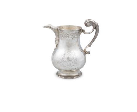 A RARE IRISH SILVER BEER JUG, Dublin c.1734, probably by Thomas Walker, the banded rim continuing onto an elongated spout, th