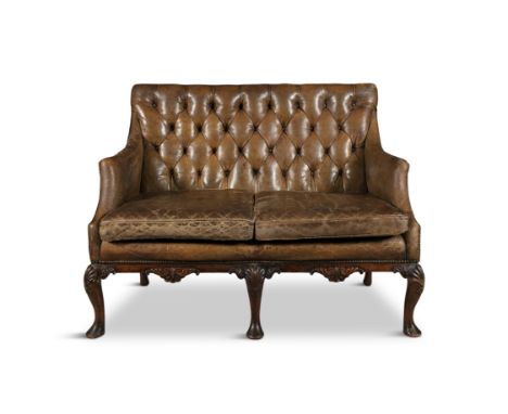 A 19TH CENTURY GEORGE III STYLE MAHOGANY FRAMED TWO SEATER LIBRARY SOFA, with button back and upholstered in tan leather, wit