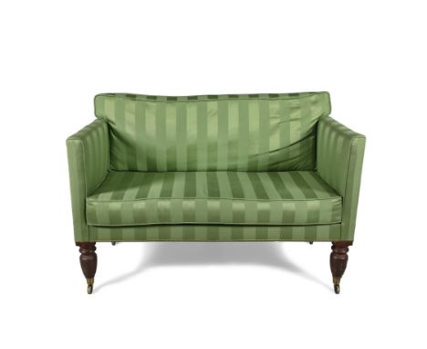 A MID 19TH CENTURY MAHOGANY FRAMED TWO-SEATER SOFA, upholstered in brass studded striped green fabric, raised on turned legs 