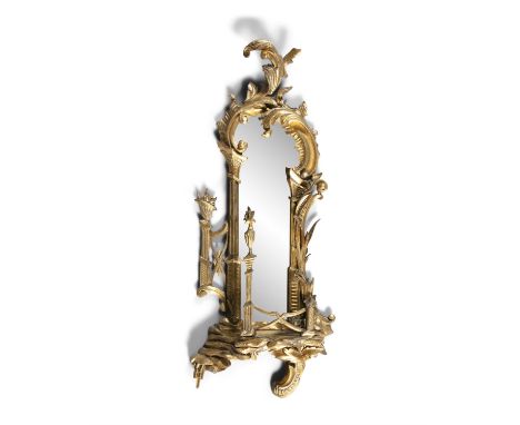 A 19TH CENTURY GEORGE III STYLE CARVED GILTWOOD MIRROR, the arched top with foliate sprays above mirror plate and shelf with 