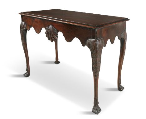 AN IRISH GEORGE II STYLE MAHOGANY CONSOLE TABLE, 19TH CENTURY the moulded top with re-entrant corners above a shaped frieze c