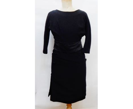 A black wool crepe 1950's cocktail dress with satin underskirt, satin button detail, satin sash, three-quarter length sleeves