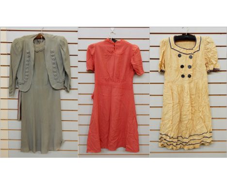 A 1940's moss grey crepe dress with matching bolero style jacket and belt, a light woollen 1940's red dress with flower butto