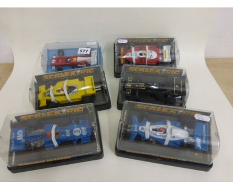 Six boxed/cased Scalextric slot cars including C134 Elf Renault RS-01, C135 Elf Tyrrell 008, C126 JPS Lotus 77, C121 Elf Tyrr