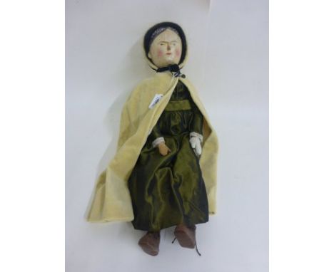 Vintage bisque headed Aunt Sally doll with wooden body and yellow cloak
