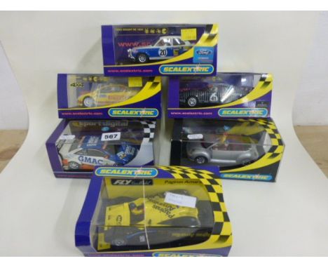 Six boxed/cased Scalextric slot cars including C2649 Renault F1 2005 Team Spirit No 5, C2569D Opel V8 Coupe 'GMAC' No 8, C250