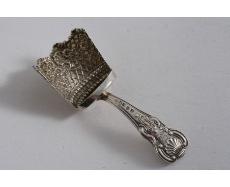 A GEORGE III CADDY SCOOP with an Hourglass pattern stem & a stamped, decorative bowl with flowers, shells & trellis work, by 