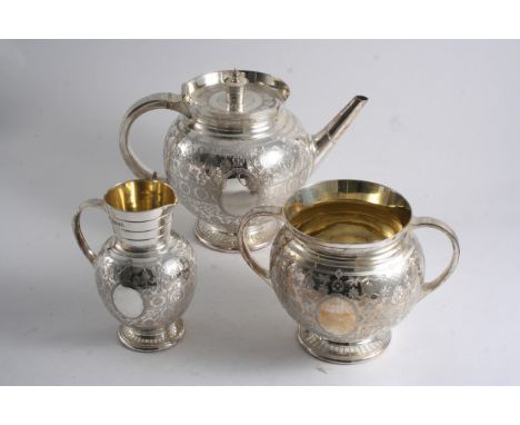 A VICTORIAN ENGRAVED THREE-PIECE TEA SET with globular bodies, C-scroll handles, circular bases & vacant oval cartouches by R