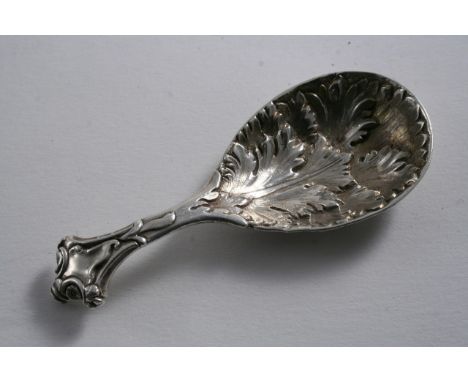 A VICTORIAN CAST CADDY SPOON with a drop-shaped foliate bowl and a shaped terminal with a vacant cartouche, by George Adams, 