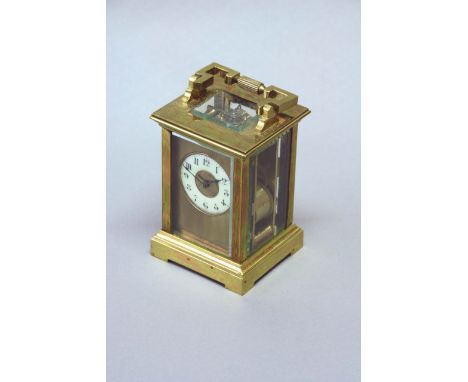 A CARRIAGE CLOCK dial cream annular, movement lever escapement, striking on a gong, 5 1/4ins. (13cms) high