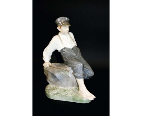 ROYAL COPENHAGEN FIGURE a large figure, Boy on Rock, Model Number 1659 and sculpted by Christian Thomsen. Marked, Royal Copen