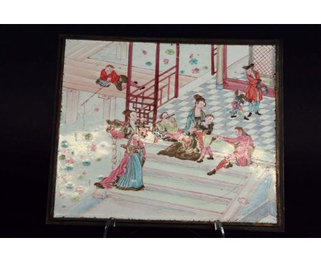 A CANTONESE ENAMEL PLAQUE delicately painted with Europeans making music and a waterside pavilion, a boy fishing amongst lotu