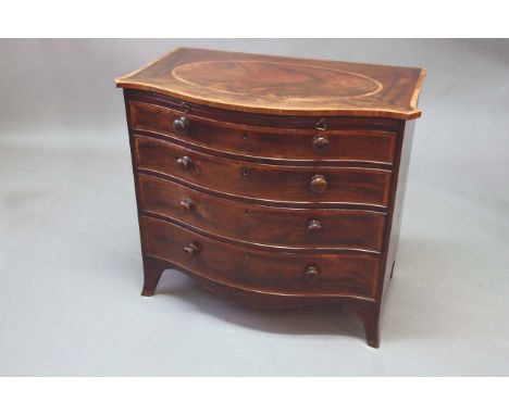 A GEORGE III MAHOGANY SERPENTINE CHEST OF DRAWERS the quarter veneered figured top inlaid with a large oval, all within tulip
