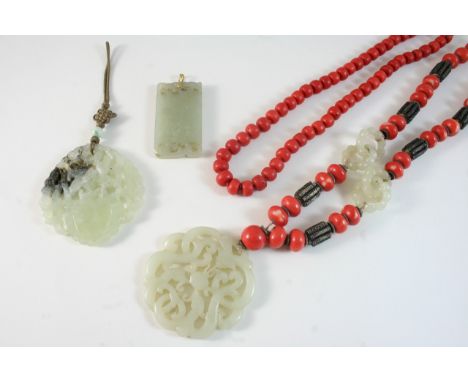 A JADE, CORAL AND SILVER NECKLACE the carved and pierced circular pendant is suspended from a silver, coral and jade necklace