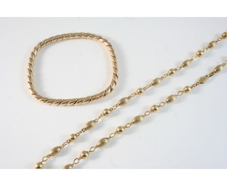 A 9CT. GOLD NECKLACE formed with ball and oval-shaped links, 44.5cm. long, 13 grams, together with a gold bangle, 14 grams.