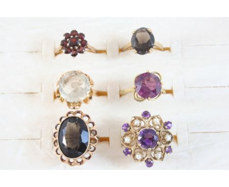 A GARNET CLUSTER RING set in gold, L,a smoky quartz single stone ring, set in gold, size N 1/2, an amethyst and cultured pear